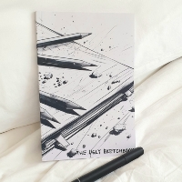 View of the sketchbook from the top, with an alcool marker